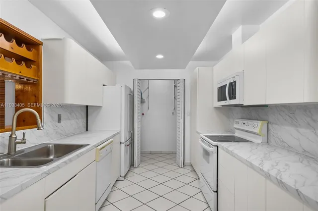 a kitchen with a sink cabinets and stainless steel appliances