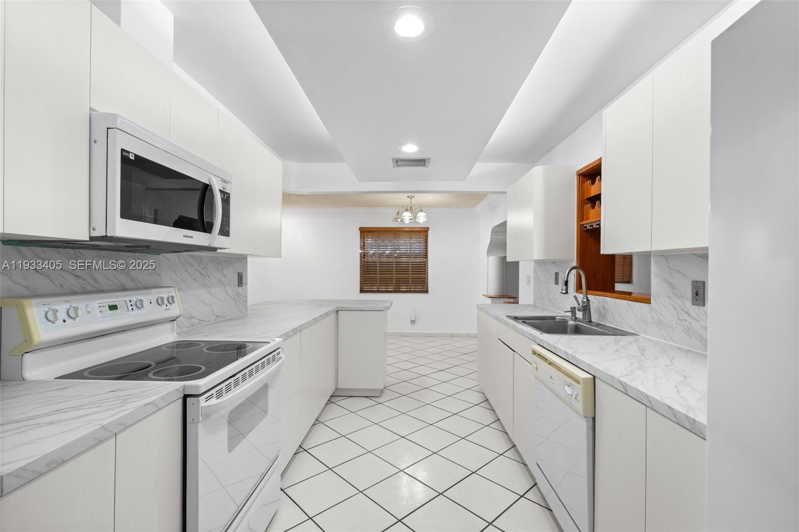 11620 Southwest 179th Terrace Miami, FL 33157 - Photo 10 of 25 a kitchen that has a sink and a stove in it