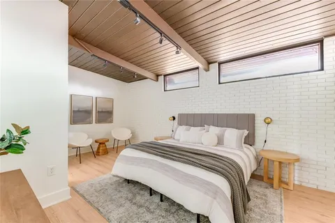 a bed room with a bed and a chair