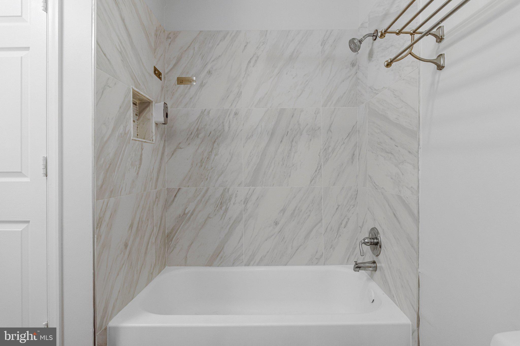 2608 Wade Road Southeast, Unit 202 Washington, DC 20020 - Photo 14 of 25 a bathroom with a bathtub