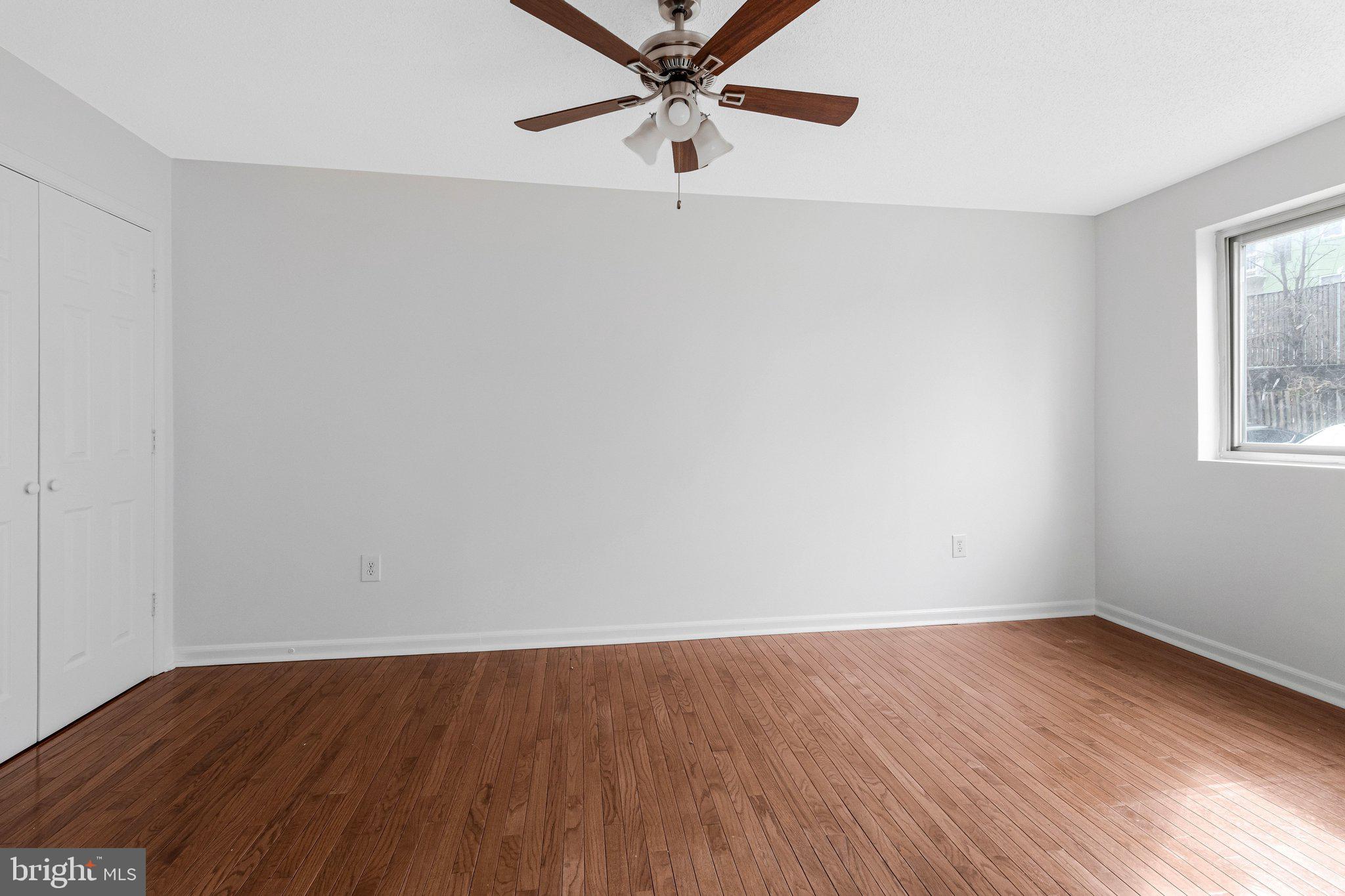 2608 Wade Road Southeast, Unit 202 Washington, DC 20020 - Photo 16 of 25 an empty room with wooden floor fan and windows