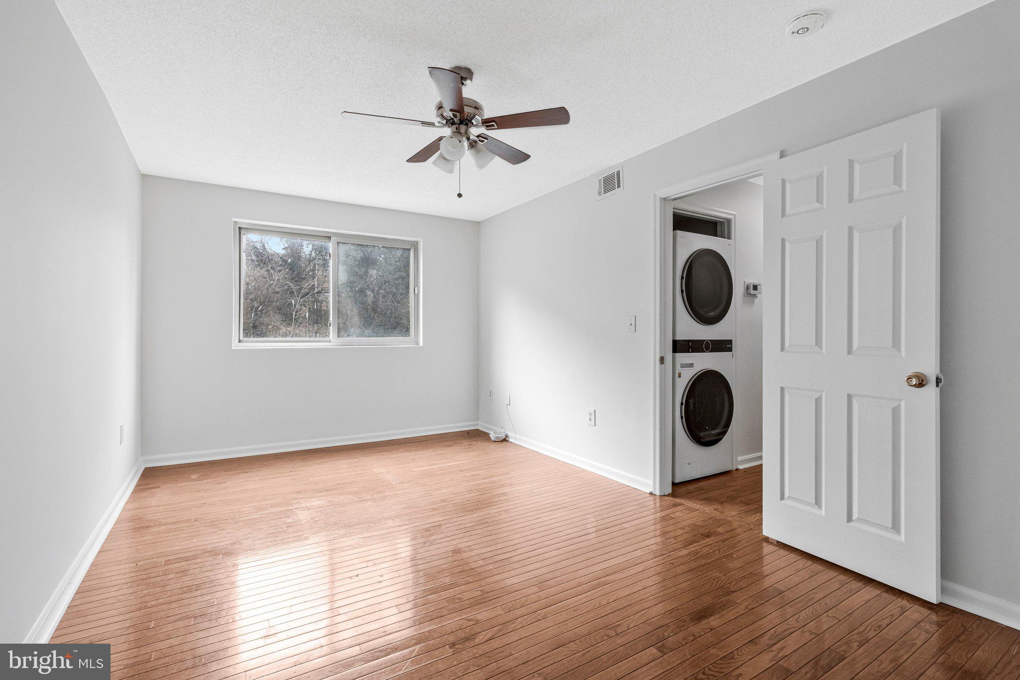 2608 Wade Road Southeast, Unit 202 Washington, DC 20020 - Photo 18 of 25 a view of an empty room with wooden floor and a window