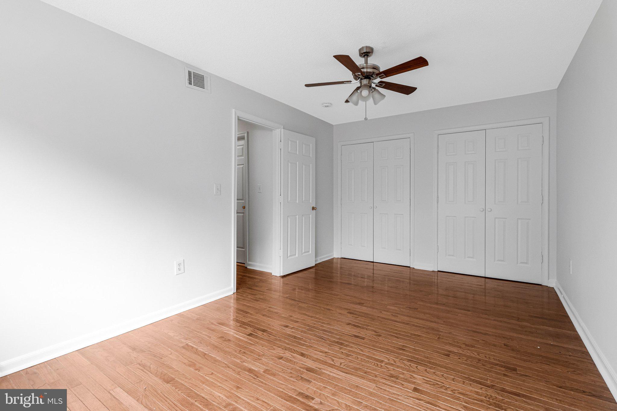 2608 Wade Road Southeast, Unit 202 Washington, DC 20020 - Photo 19 of 25 a view of empty room with wooden floor and ceiling fan