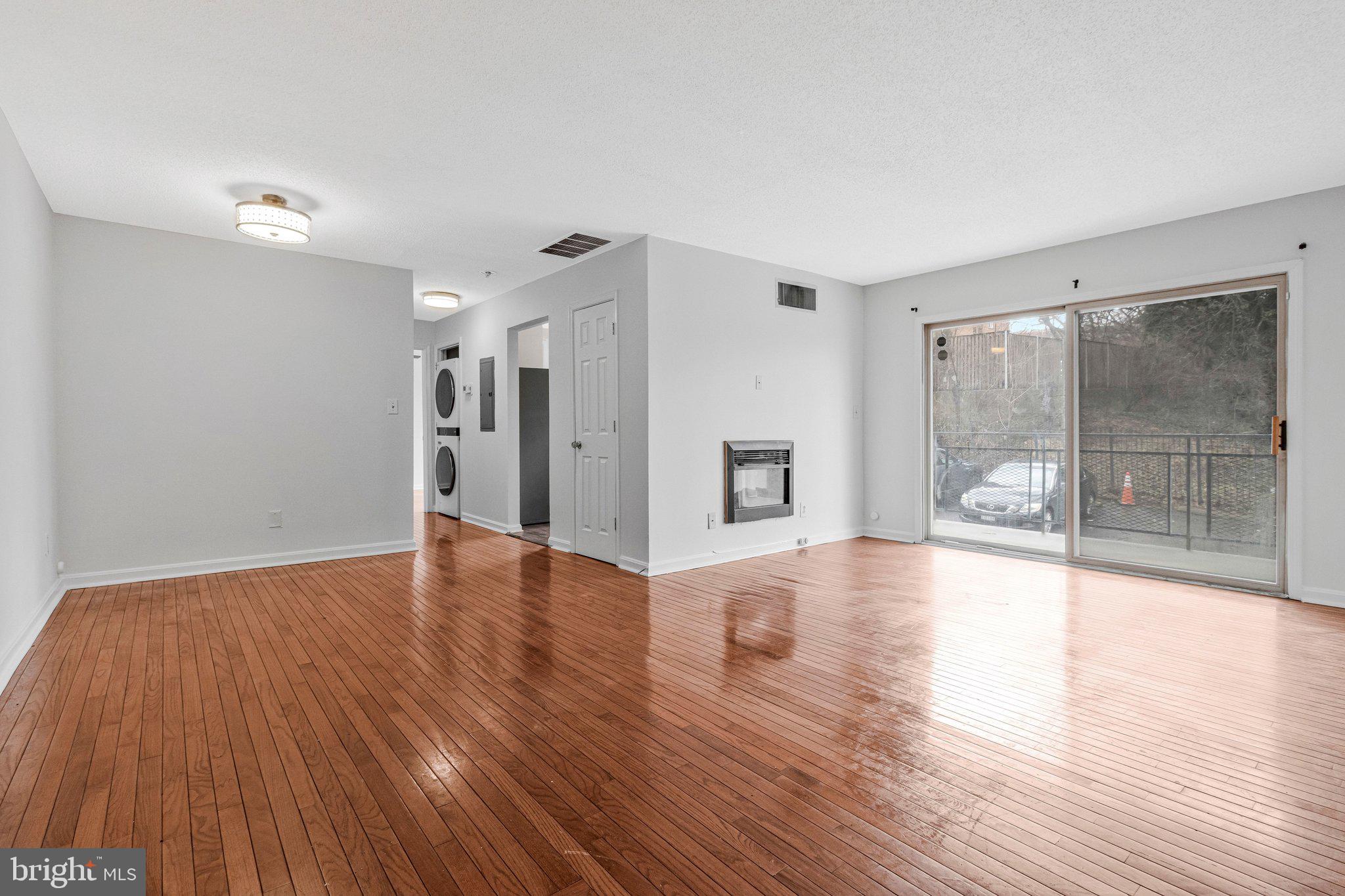2608 Wade Road Southeast, Unit 202 Washington, DC 20020 - Photo 4 of 25 a view of an empty room with wooden floor and a window