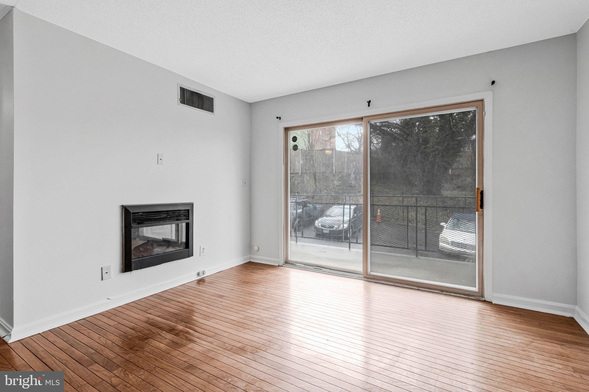 2608 Wade Road Southeast, Unit 202 Washington, DC 20020 - Photo 5 of 25 a view of an empty room with wooden floor and a window