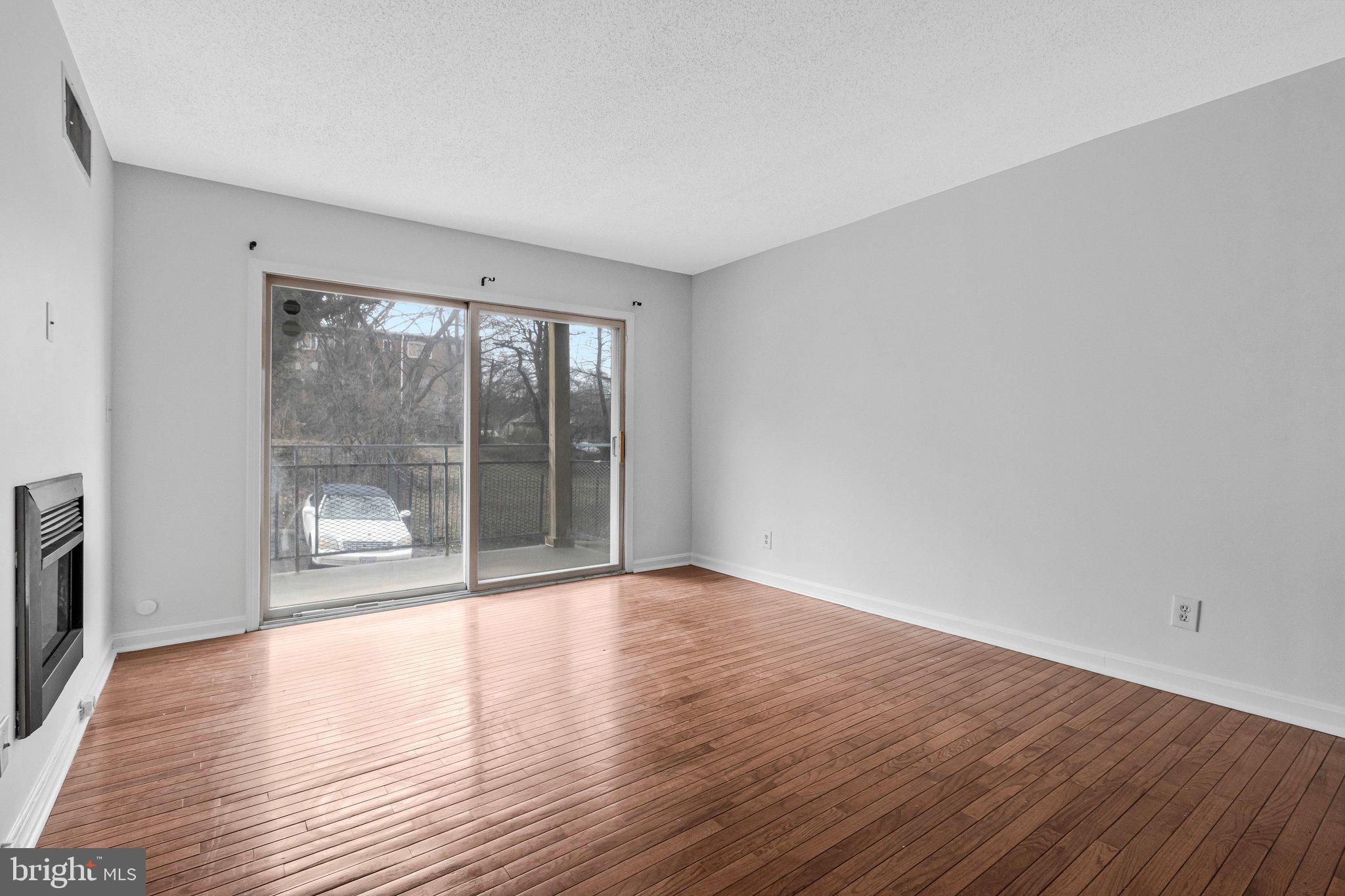 2608 Wade Road Southeast, Unit 202 Washington, DC 20020 - Photo 7 of 25 a view of an empty room with wooden floor and a window