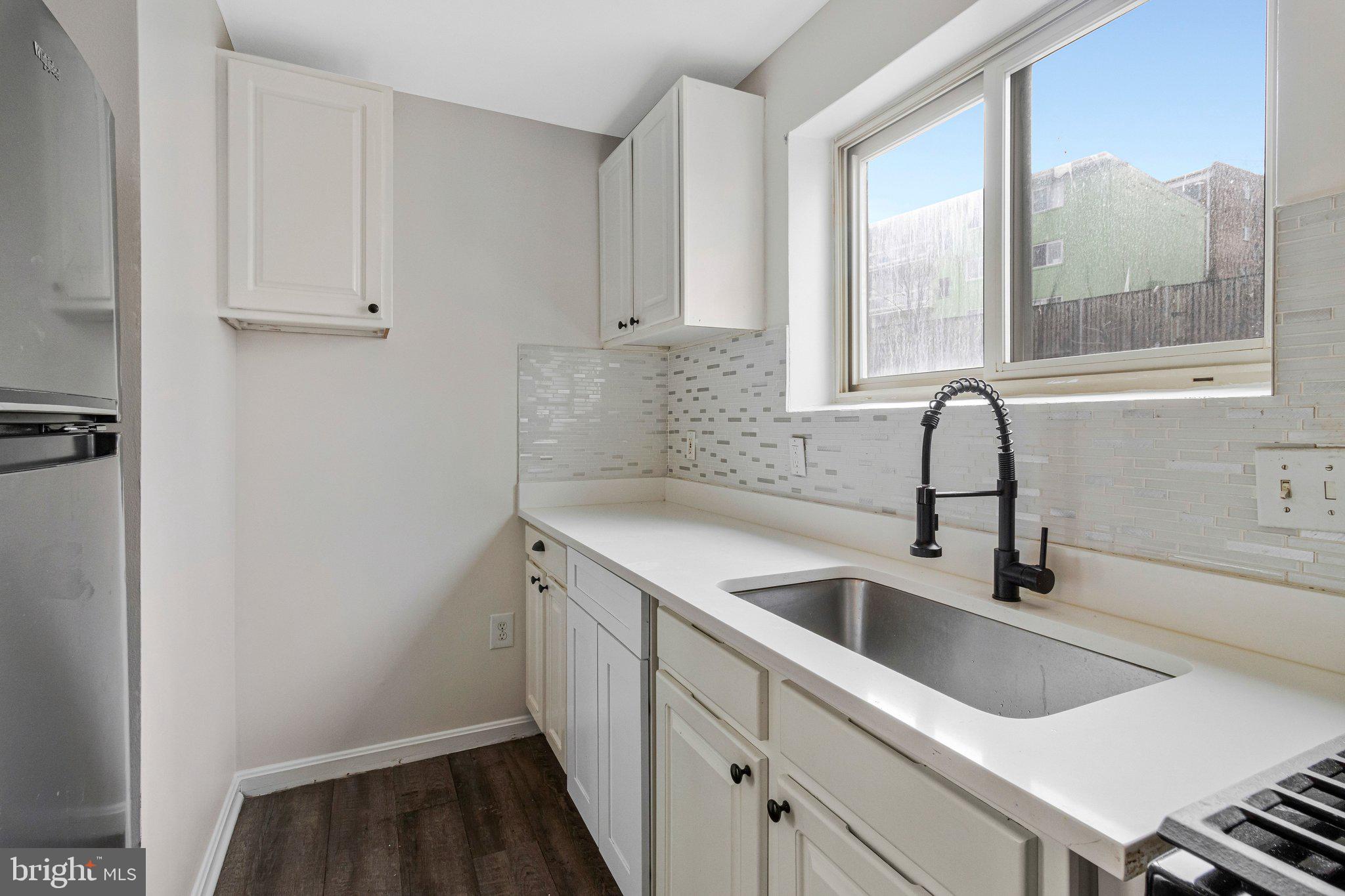 2608 Wade Road Southeast, Unit 202 Washington, DC 20020 - Photo 9 of 25 a kitchen with a sink and large window