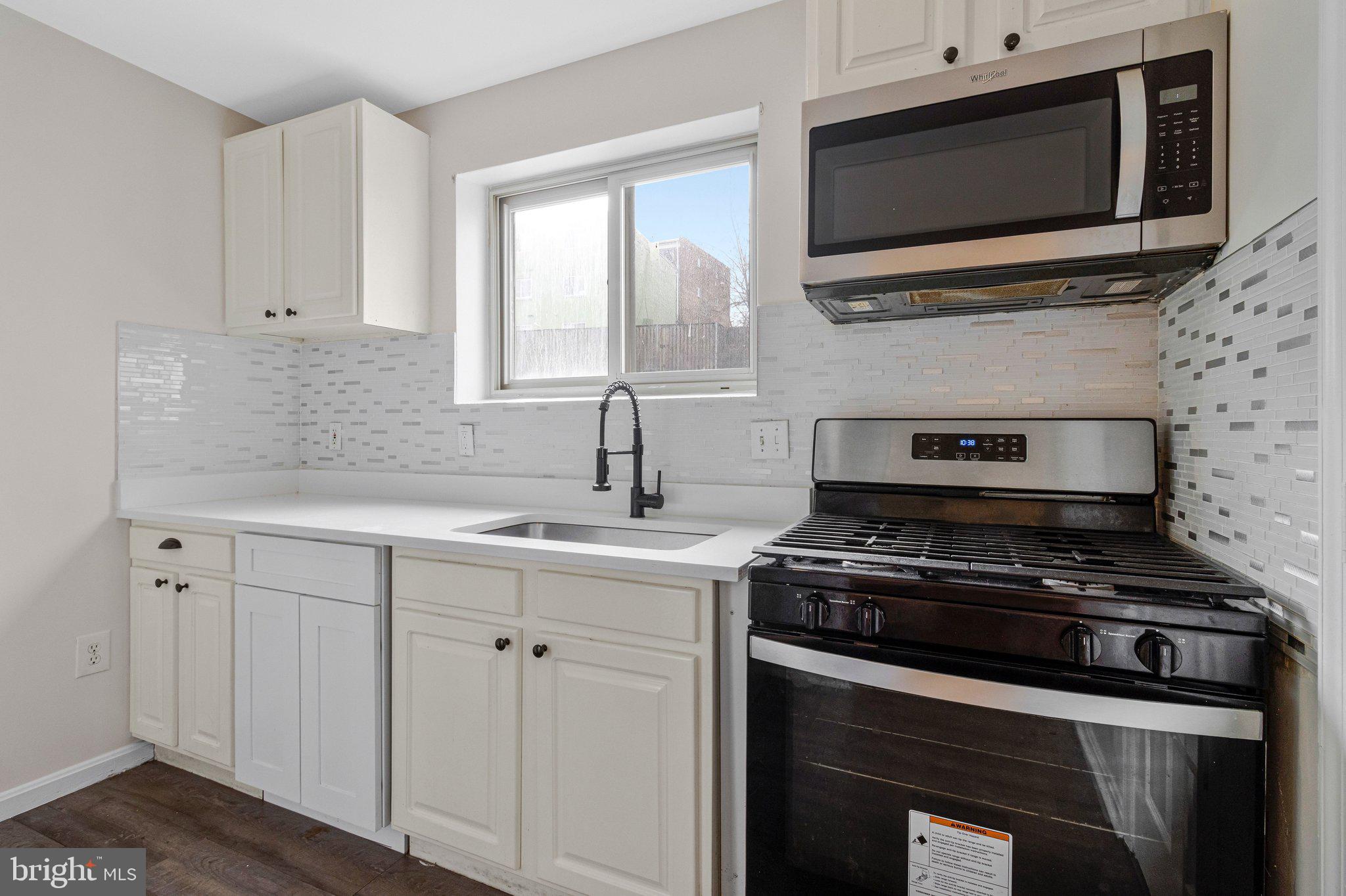 2608 Wade Road Southeast, Unit 202 Washington, DC 20020 - Photo 10 of 25 a kitchen with cabinets stainless steel appliances and a sink