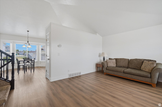 5576 South 4100th Street West Roy, UT 84067 - Photo 6 of 35 Living room, LVP flooring, vaulted ceiling