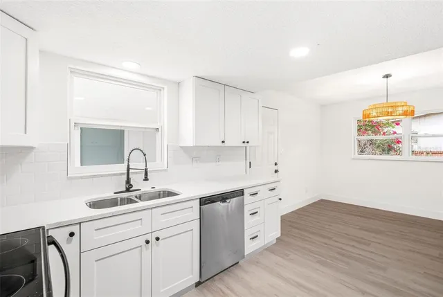 a kitchen with a sink cabinets and window