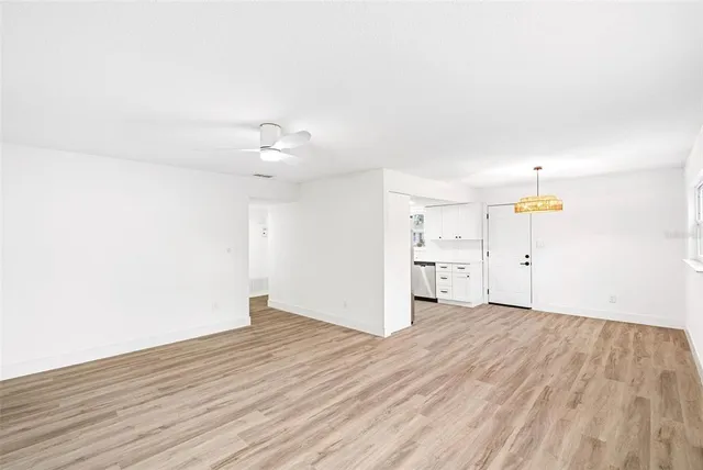 a view of a kitchen with wooden floor and a sink