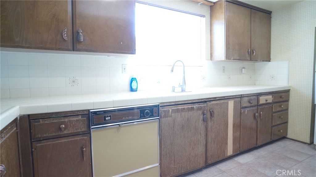 20522 Seton Hill Drive Walnut, CA 91789 - Photo 12 of 51 a kitchen with stainless steel appliances white cabinets and a sink