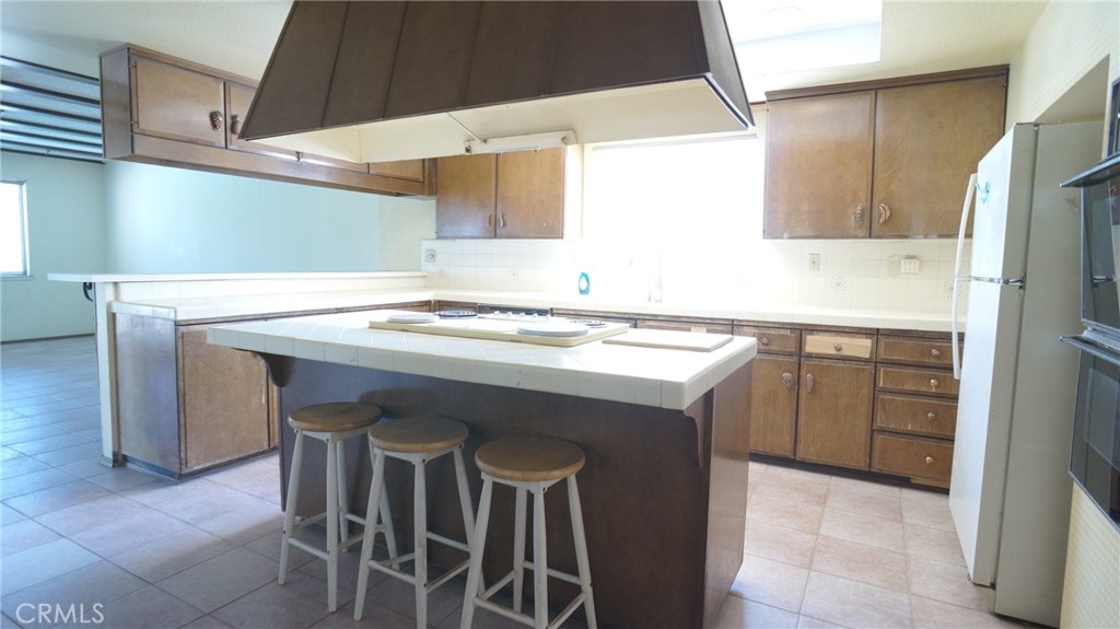 20522 Seton Hill Drive Walnut, CA 91789 - Photo 8 of 51 a kitchen with a sink a stove a refrigerator and island