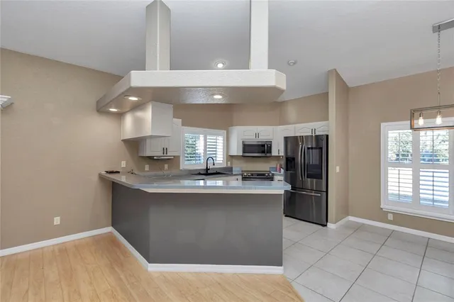 a kitchen with a sink stainless steel appliances and cabinets