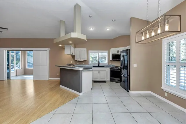an aerial view of a house with yard and patio