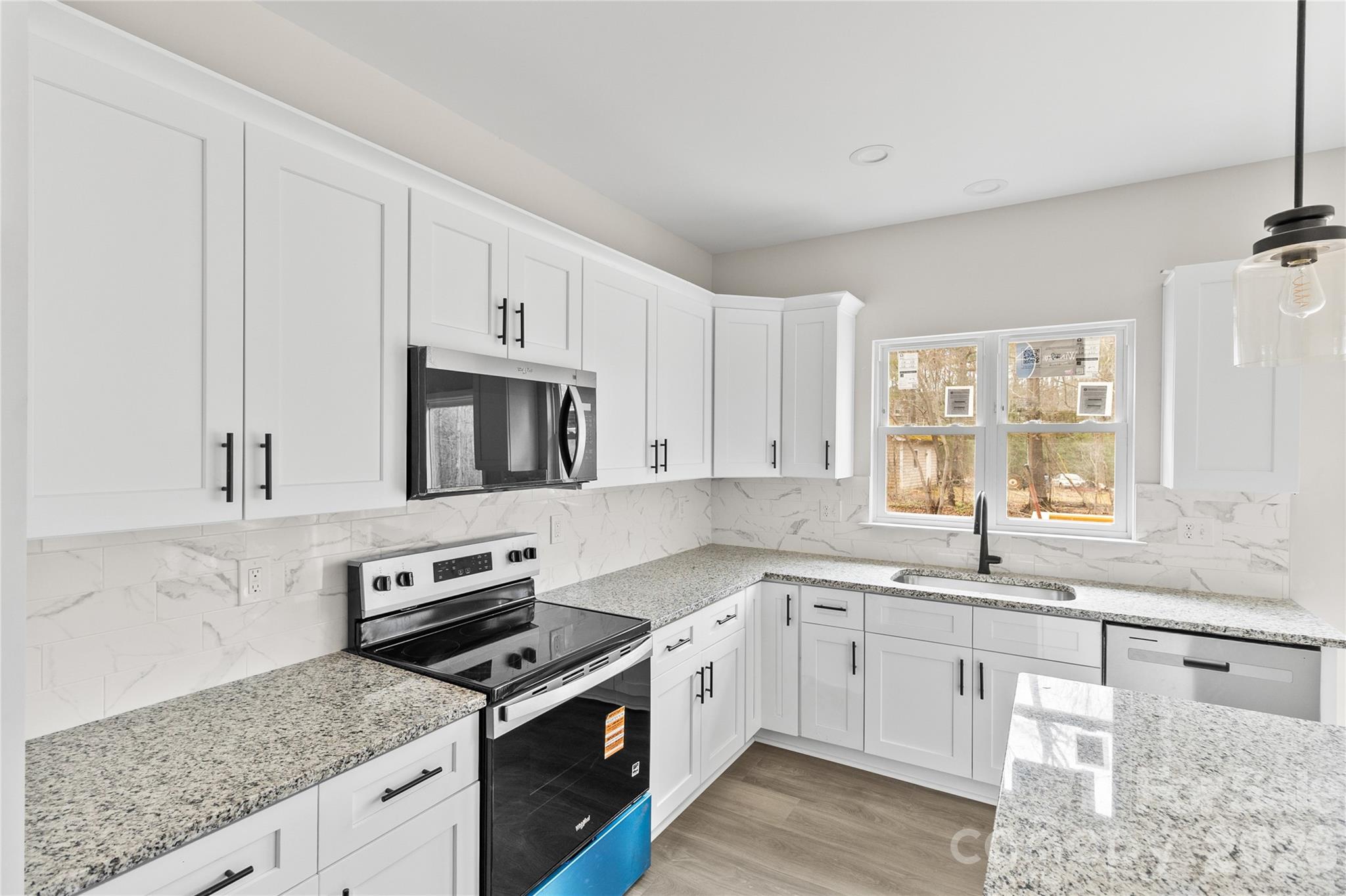 3692 Shannon Loop Denver, NC 28037 - Photo 6 of 47 a kitchen with stainless steel appliances granite countertop white cabinets and window