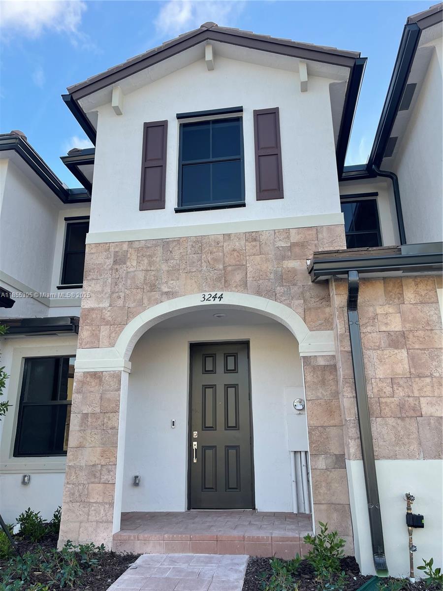 3244 West 114th Terrace, Unit 3244 Hialeah, FL 33018 - Photo 1 of 16 a front view of a house with glass windows