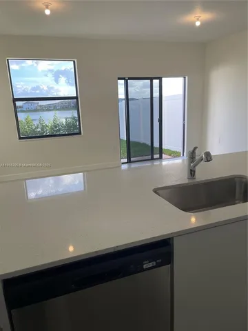 a kitchen with a sink and a window
