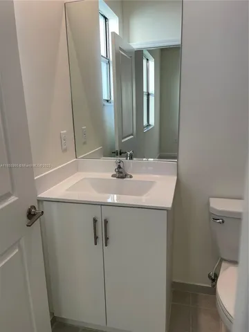 a bathroom with a sink toilet and mirror