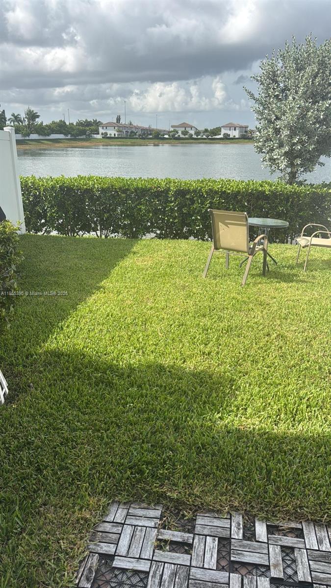 3244 West 114th Terrace, Unit 3244 Hialeah, FL 33018 - Photo 16 of 16 a view of a lake with a big yard and large trees