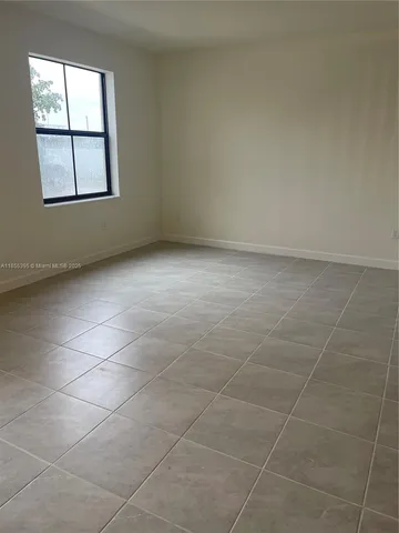 an empty room with windows and entrance