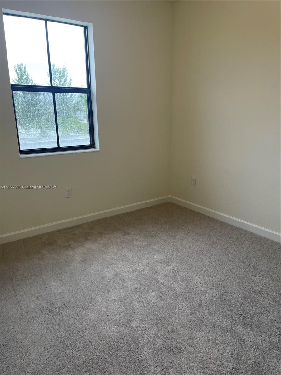 3244 West 114th Terrace, Unit 3244 Hialeah, FL 33018 - Photo 8 of 16 an empty room with a window