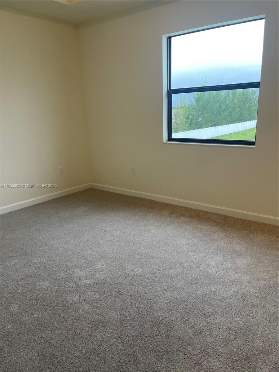 3244 West 114th Terrace, Unit 3244 Hialeah, FL 33018 - Photo 9 of 16 an empty room with a window