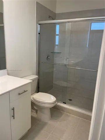 a bathroom with a shower and a toilet