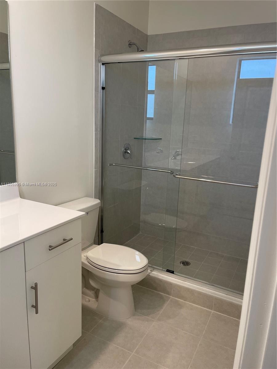 3244 West 114th Terrace, Unit 3244 Hialeah, FL 33018 - Photo 10 of 16 a bathroom with a shower and a toilet