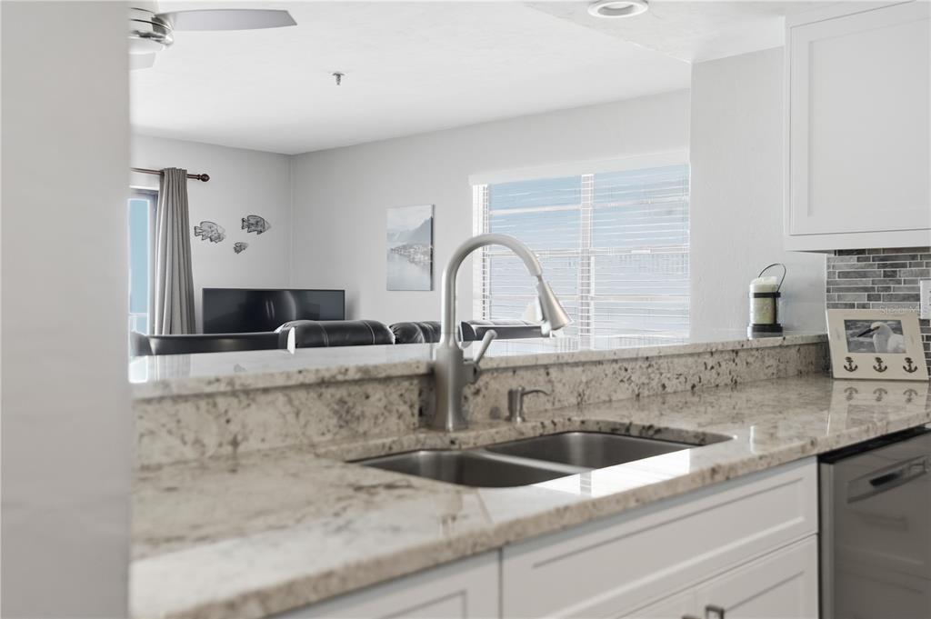 16330 Gulf Boulevard, Unit 306 Redington Beach, FL 33708 - Photo 12 of 39 a close view of a sink and a microwave in a kitchen