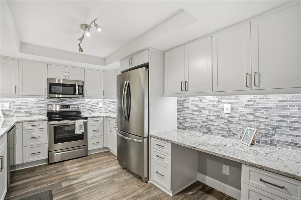16330 Gulf Boulevard, Unit 306 Redington Beach, FL 33708 - Photo 13 of 39 a kitchen with stainless steel appliances granite countertop a refrigerator sink and stove