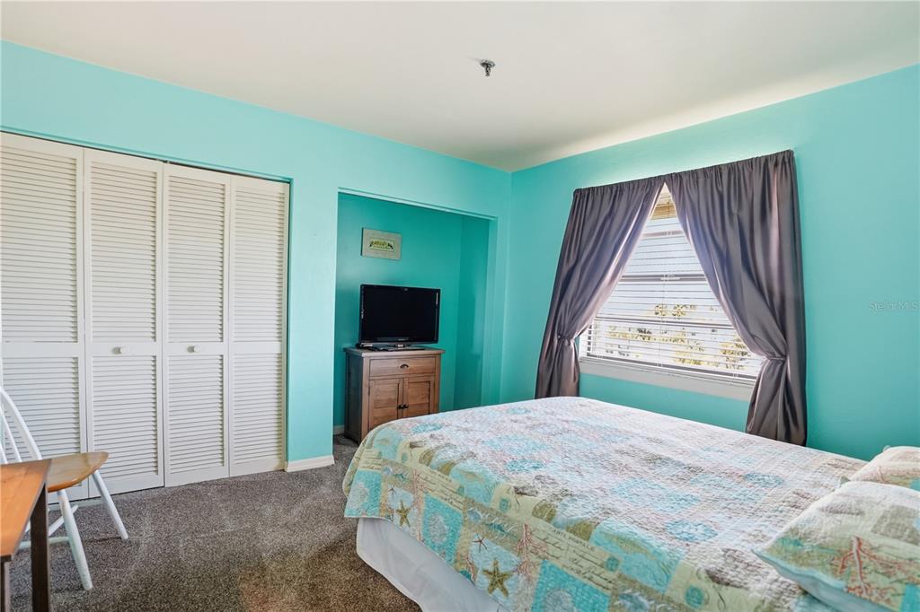 16330 Gulf Boulevard, Unit 306 Redington Beach, FL 33708 - Photo 24 of 39 a bedroom with a bed and a flat screen tv