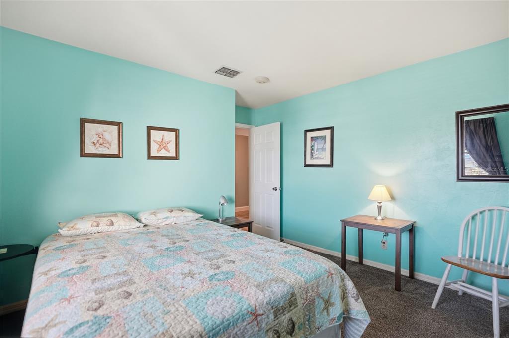 16330 Gulf Boulevard, Unit 306 Redington Beach, FL 33708 - Photo 25 of 39 a bedroom with a bed and a lamp
