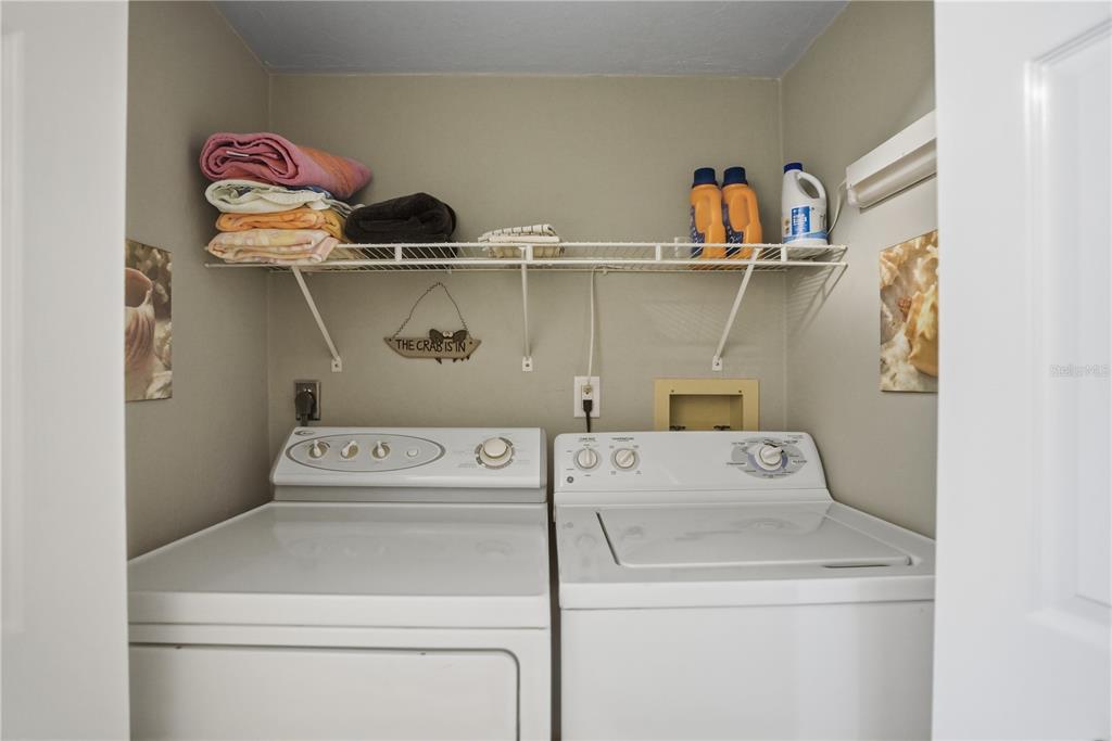 16330 Gulf Boulevard, Unit 306 Redington Beach, FL 33708 - Photo 27 of 39 a utility room with dryer and washer