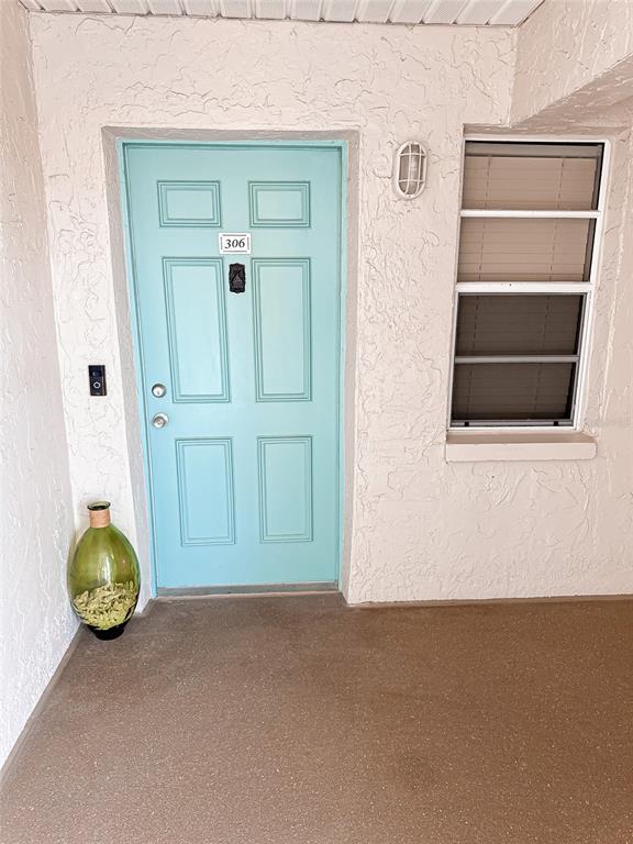 16330 Gulf Boulevard, Unit 306 Redington Beach, FL 33708 - Photo 28 of 39 an empty room with wooden floor and cabinet