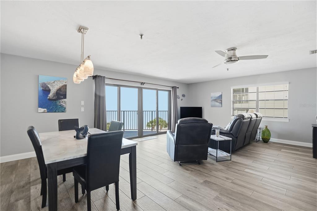 16330 Gulf Boulevard, Unit 306 Redington Beach, FL 33708 - Photo 4 of 39 a dining room with furniture a chandelier and wooden floor