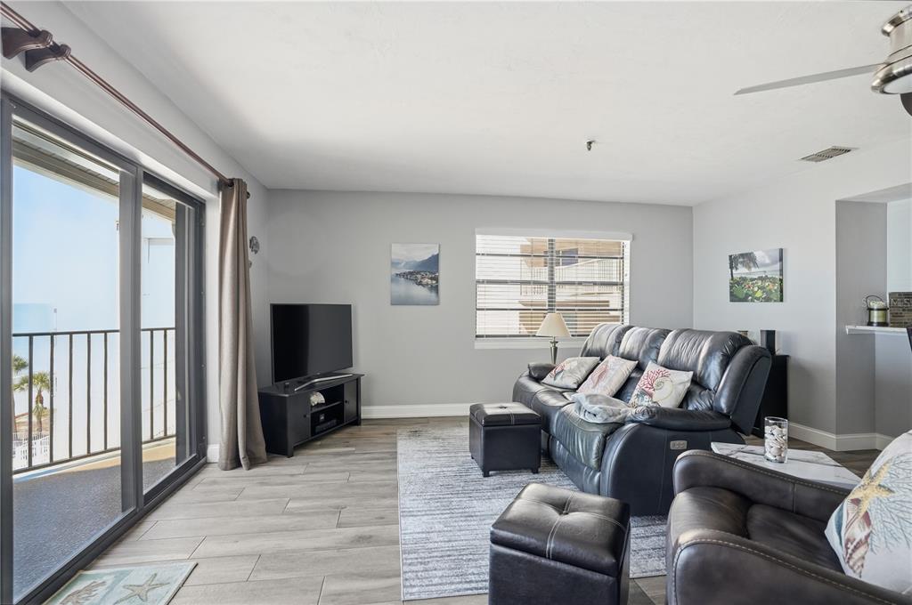 16330 Gulf Boulevard, Unit 306 Redington Beach, FL 33708 - Photo 7 of 39 a living room with furniture a flat screen tv and a window