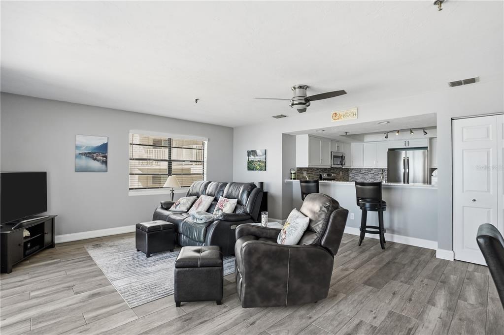 16330 Gulf Boulevard, Unit 306 Redington Beach, FL 33708 - Photo 8 of 39 a living room with furniture and a flat screen tv