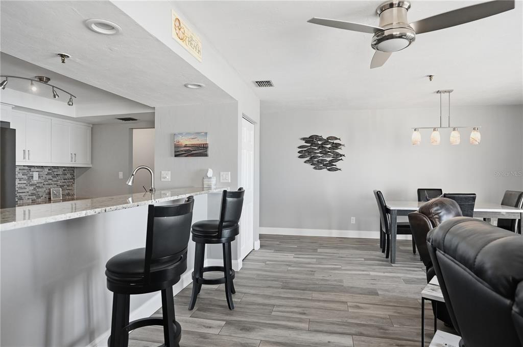 16330 Gulf Boulevard, Unit 306 Redington Beach, FL 33708 - Photo 10 of 39 a view of a dining room with furniture and wooden floor