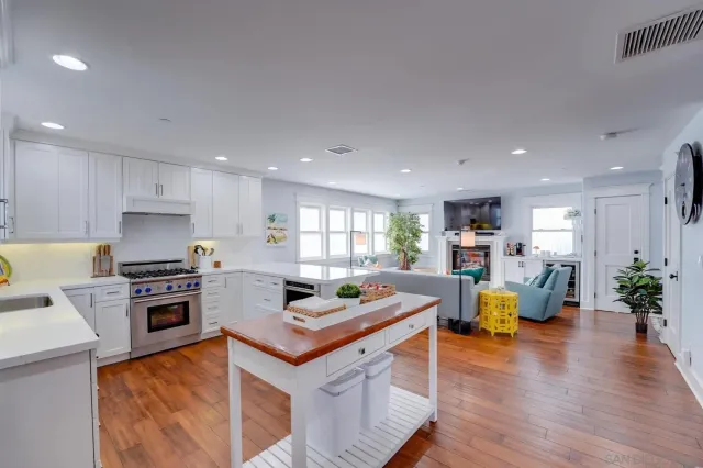 a kitchen with a stove cabinets and wooden floor