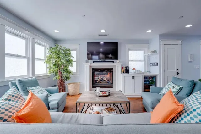 a living room with furniture a flat screen tv and a fireplace