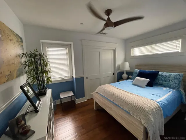 a bedroom with a bed and a potted plant