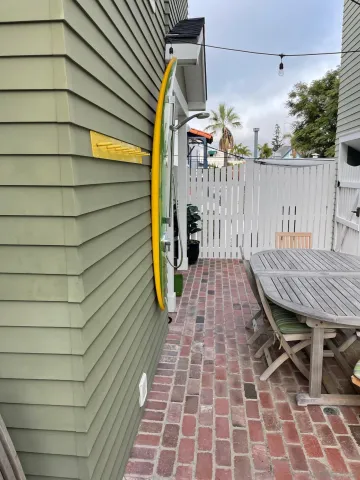 a backyard of a house with table and chairs