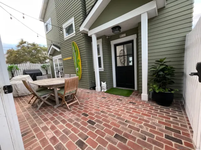 a backyard of a house with outdoor seating