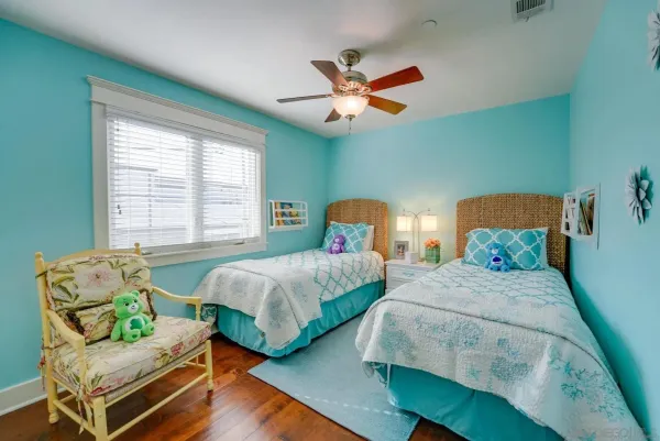 a bedroom with two beds and a window