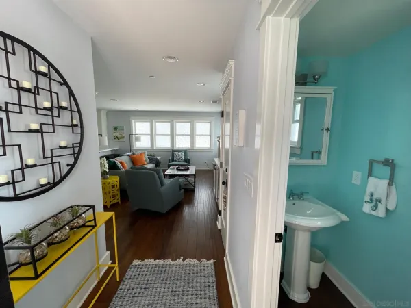 a view of a livingroom with furniture and hardwood floor