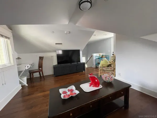 a living room with furniture and flat screen tv
