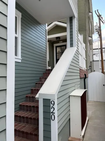 a view of a house with entryway and wooden stairs