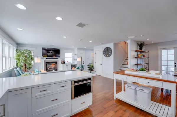 a kitchen with stainless steel appliances granite countertop a refrigerator and a stove top oven