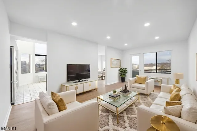 a living room with furniture a rug and a flat screen tv